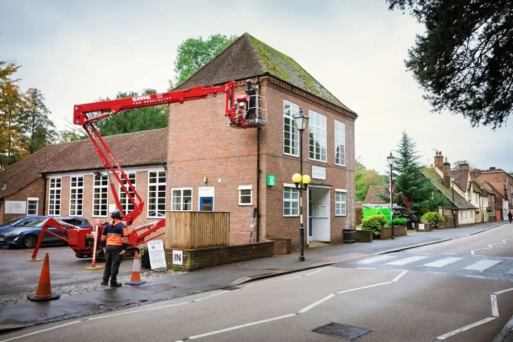 PP Gutters, cleaning a commercial property's gutters from a cherry picker, in West Wycombe