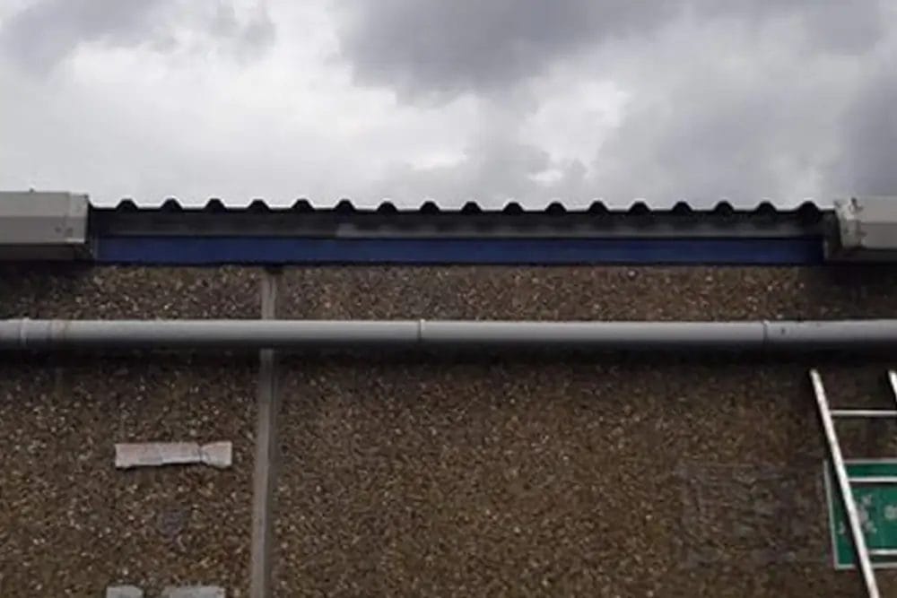 PP Gutters commercial roof and gutter cleaning services. Showing a damaged commercial gutter before being repaired.