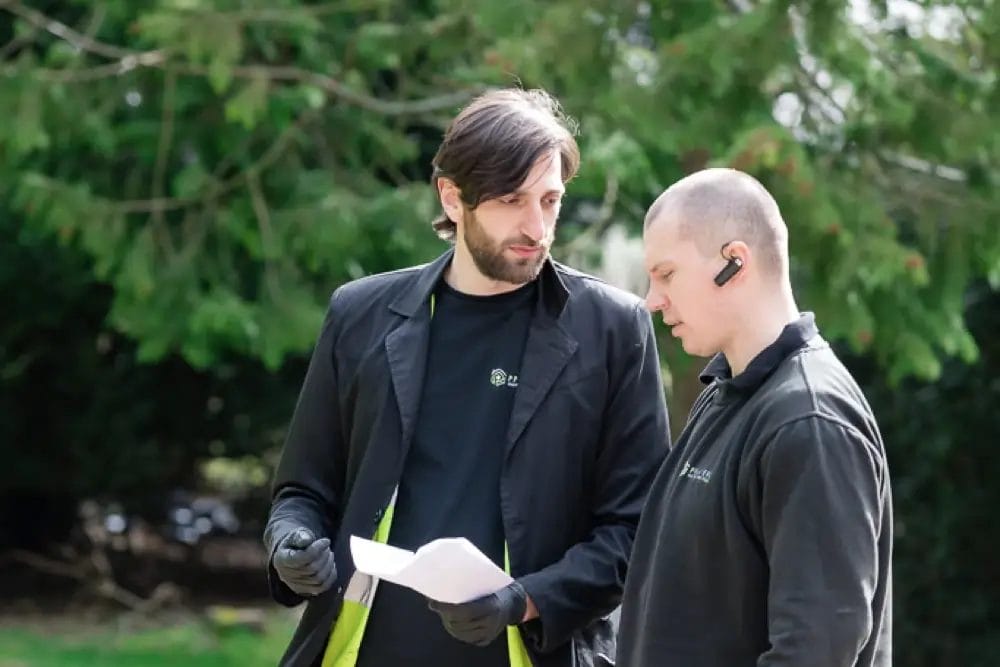 PP Gutters roof and gutter cleaning services. Team members discussing a project