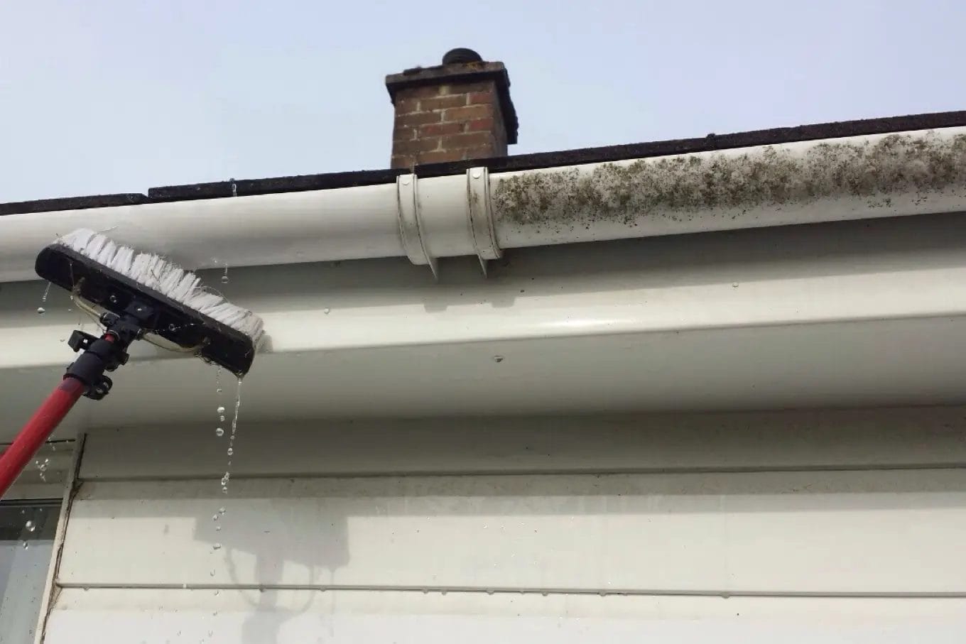 PP Gutters residential roof and gutter cleaning services. A residential property's gutter and fascias being cleaned.