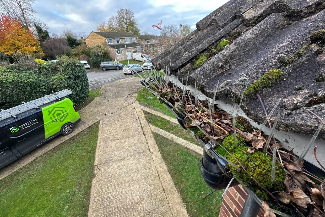 PP Gutters domestic gutter cleaning services. Showing a residential property's gutters blocked with debris.