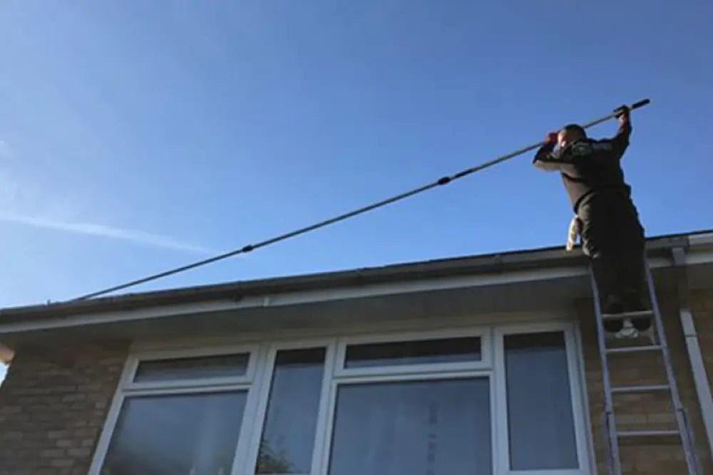 PP Gutters residential roof and gutter cleaning services. A residential property's gutter being cleaned