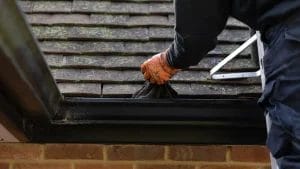 PP Gutters residential gutter cleaning services. Showing a residential property's gutter being maintained.