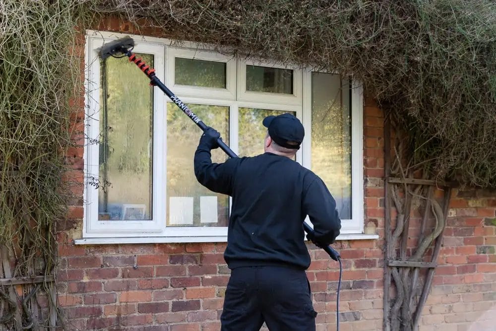 PP Gutters residential roof and gutter cleaning services. A property's uPVC window being cleaned using softwashing