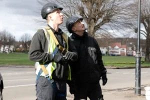 PP Gutters, the roof and gutter cleaning specialists. Image of PP Gutters technicians checking a roof and gutters for moss.