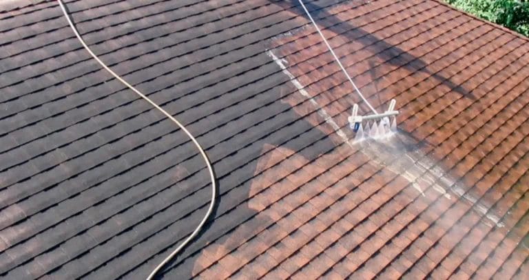 PP Gutters residential and commercial roof and gutter cleaning services. A property's roof being washed down.