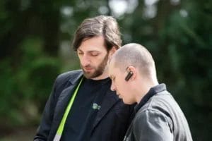 PP Gutters roof and gutter cleaning services. Team members discussing a project.