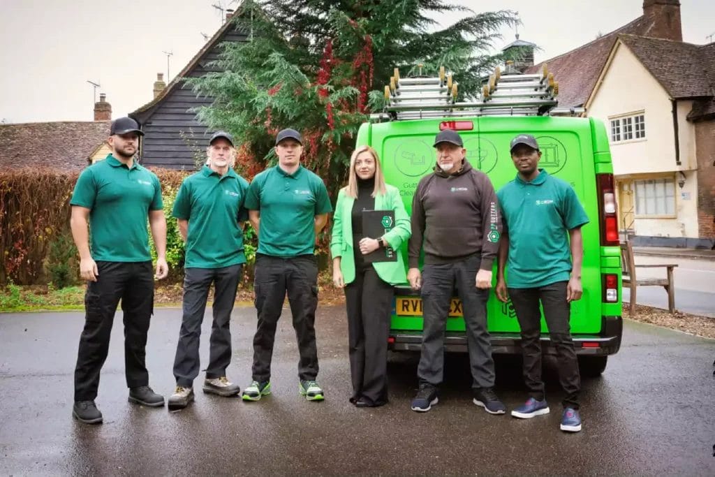 PP Gutters. The gutter and roof cleaning professionals. Team photo with company van