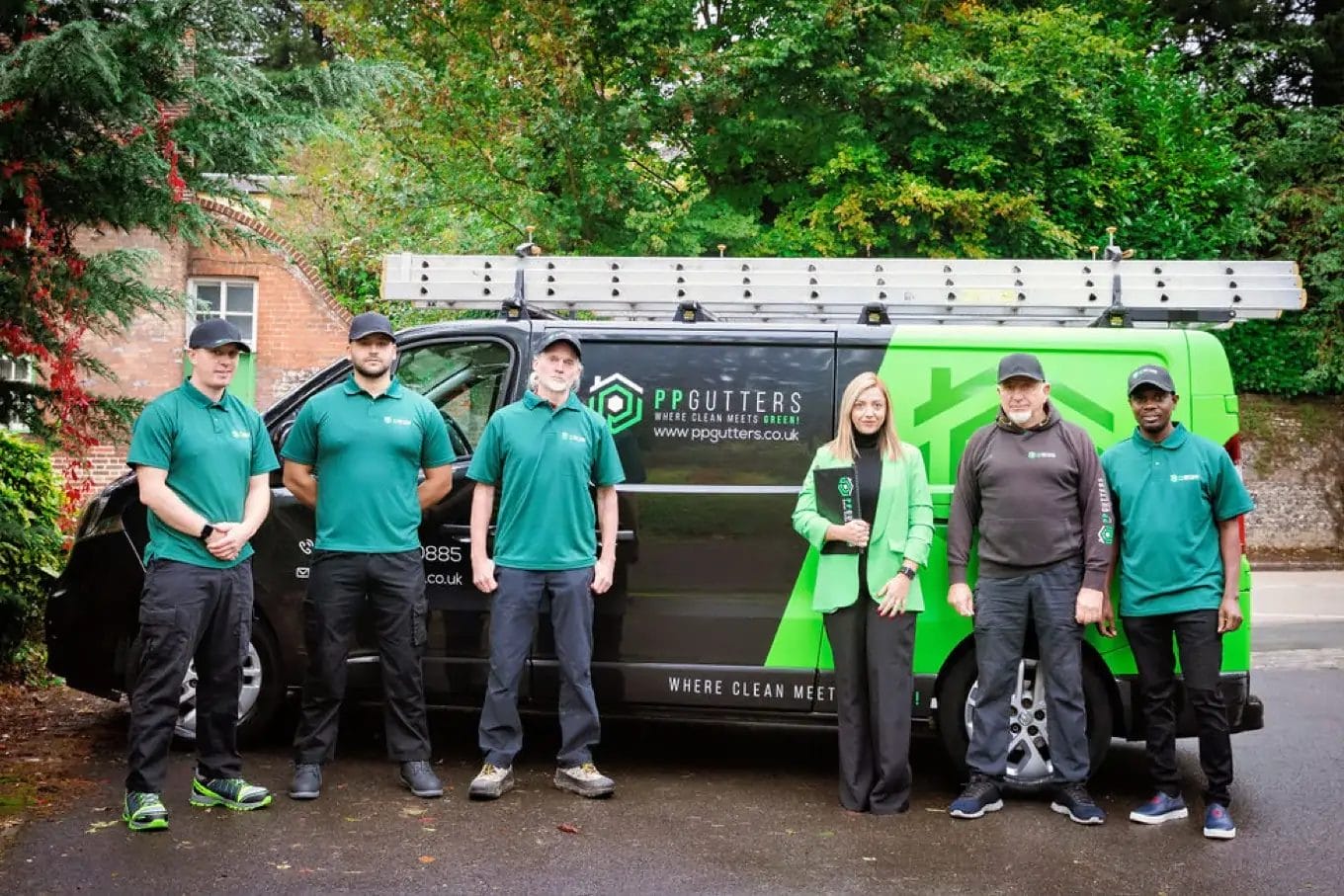 PP Gutters. The gutter and roof cleaning professionals. Team photo with company van
