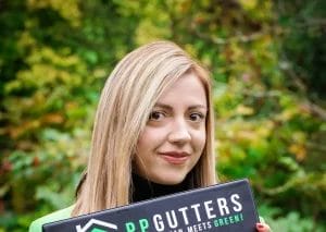 PP Gutters, the roof and gutter cleaning specialists. Image of PP Gutters team member holding a clipboard.