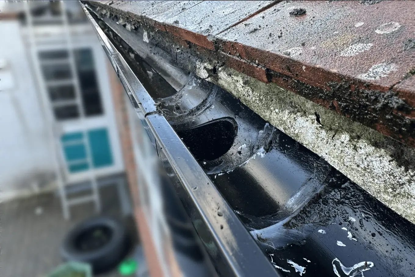 School gutter cleaning in London, Watford and High Wycombe - photo of a gutter at St Mary's CofE School in Aylesbury, after it's been cleared of debris by PP Gutters.