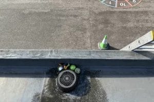 School gutter and roof clearing in London, Watford and High Wycombe - photo of a flat roof with built in gutter at St Mary's CofE School in Aylesbury, before it's been cleared of various balls and debris by PP Gutters.