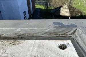 School gutter and roof clearing in London, Watford and High Wycombe - photo of a flat roof with built in gutter at St Mary's CofE School in Aylesbury, after it's been cleared of various balls and debris by PP Gutters.