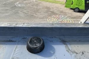 School gutter and roof clearing in London, Watford and High Wycombe - photo of a flat roof with built in gutter at St Mary's CofE School in Aylesbury, after it's been cleared of various balls and debris by PP Gutters.