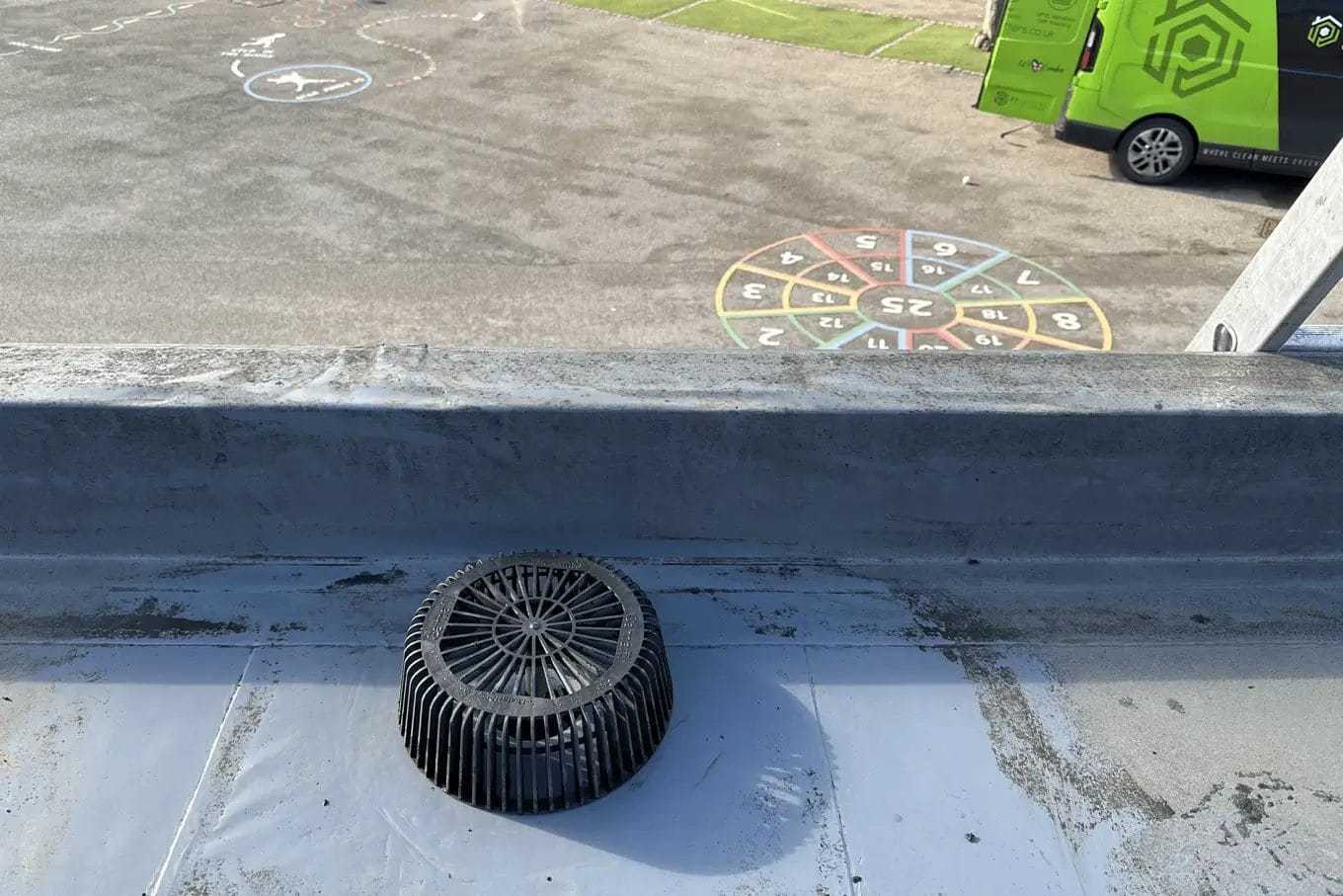 School gutter and roof clearing in London, Watford and High Wycombe - photo of a flat roof with built in gutter at St Mary's CofE School in Aylesbury, after it's been cleared of various balls and debris by PP Gutters.