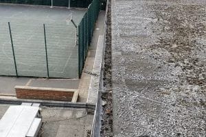 School gutter and roof cleaning in London, Watford and High Wycombe - photo of a flat roof and gutter before it's been cleared of debris by PP Gutters.