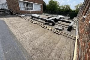 School roof clearing in London, Watford and High Wycombe - photo of a flat roof at Mote School in Fulham, after it's been cleared of debris by PP Gutters.