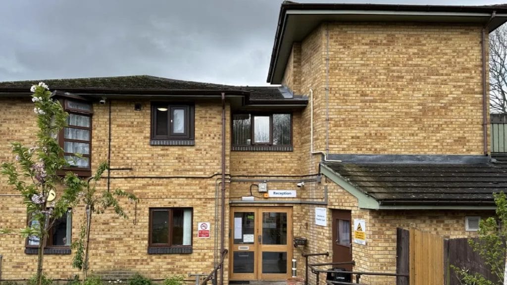 PP Gutters roof and gutter cleaning services. Before photo of an NHS hospital in Harrow, with blocked downpipes and gutters.